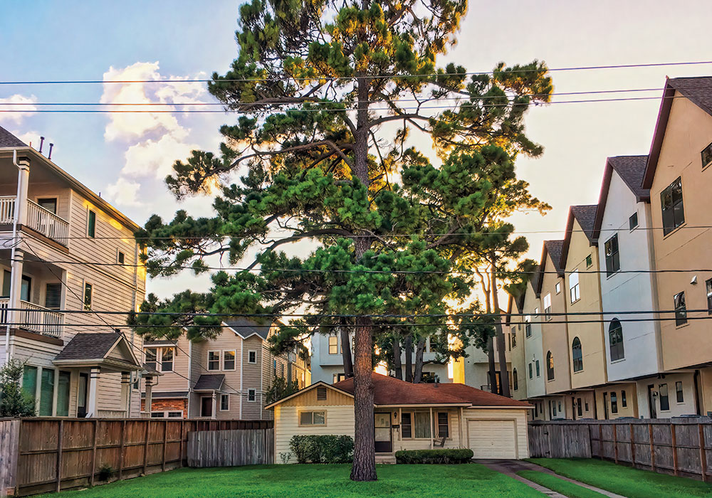 A lone single-family house sits among town houses on Beall Street in Houston. Photo by Adam Clay.