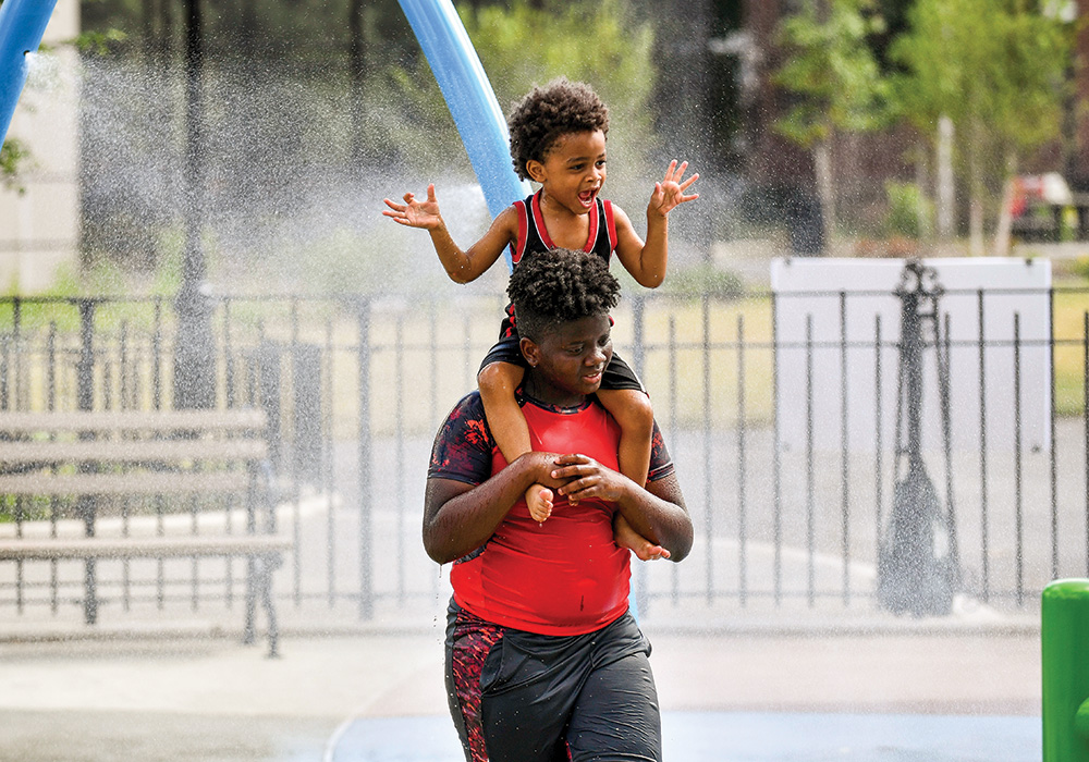 Kids play in the water spray at the Big Park on Staten Island shortly after the reconstructed park opened in 2018. The fifth NYC Parks Community Parks Initiative project in the borough also has seven rain gardens that help capture about 1.5 million gallons of stormwater a year. Photo courtesy NYC Parks.