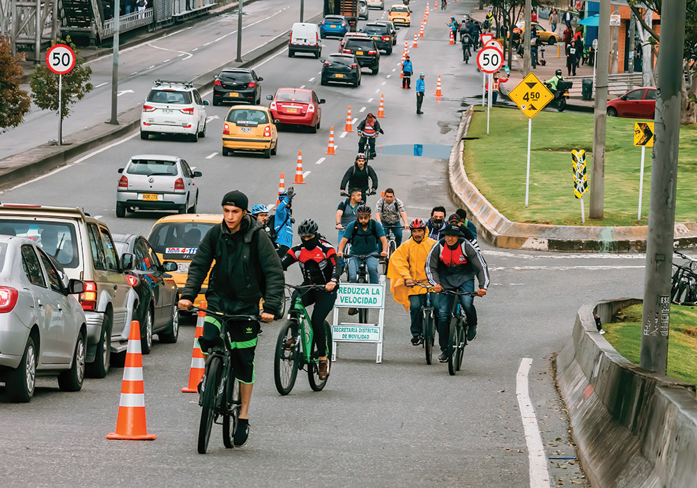 Bogotá residents take advantage of a temporary bike lane along busy 80 Street Avenue, one of many pop-ups added to the city’s 340 miles of existing bike lanes. Photo by Gabriel Leonardo Guerrero Bermudez/iStock Editorial.