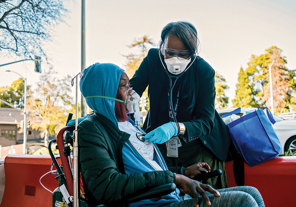 A respiratory therapist cares for a patient in Oakland, California, where a COVID-19 Racial Disparities Task Force was created in May. Race is a huge factor in virus fatality rates due to “long-standing systemic health and social inequities,” the CDC says. Photo by Alexandra Hootnick/The New York Times.