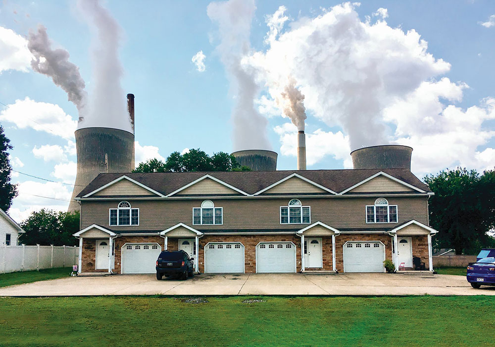 The John Amos Power Plant looms over nearby apartments in Winfield, West Virginia. During the onset of the pandemic in the U.S., the Trump administration significantly relaxed regulations that limit toxic metal output from coal-fired plants. John Raby/AP Photo.