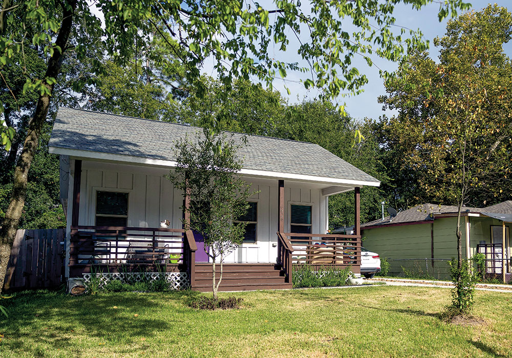 Stephanie Dickenson, owner of the home, wasn’t sold at first on the CLT model of homeownership because the land wasn’t included. But the longtime renter wanted a place of her own in Houston, and the price was right. She relishes the freedom to decorate as she likes, including a purple front door. Photo by Gustavo Huerta.