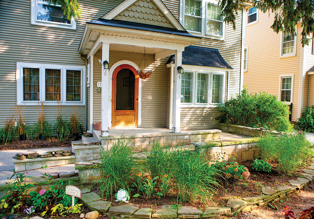 The entrance to this house is equipped with stairs and a wheelchair ramp, both of which complement the overall exterior aesthetic. Photo by Douglas Levere, courtesy IDeA Center.