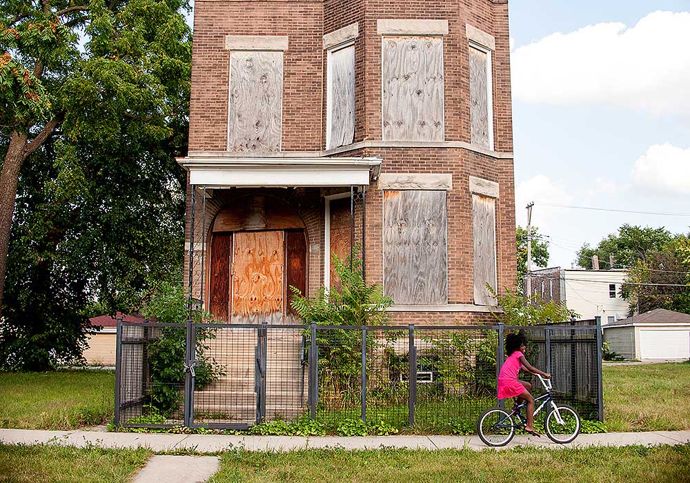 Planning Winter 2021 6 Ways to Help Bridge the Racial Wealth Gap Artist Tonika Lewis Johnson cataolgues the individual, societal, and economic impacts of segregation on her hometown of Chicago, one of the most racially segregated cities in the country. Here, a young girl rides her bike past a boarded up building on the city's South Side. Photo by Tonika Lewis Johnson.