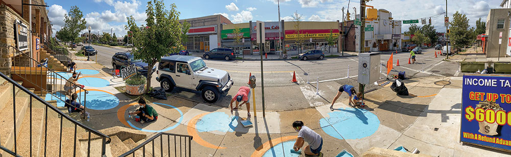 Planning Winter 2021 Pandemic-Proof Community Service Volunteers paint the sidewalk — and physically distance — as part of Neighborhood Design Center’s Designs for Distancing Project. Photo by Megan Oliver.