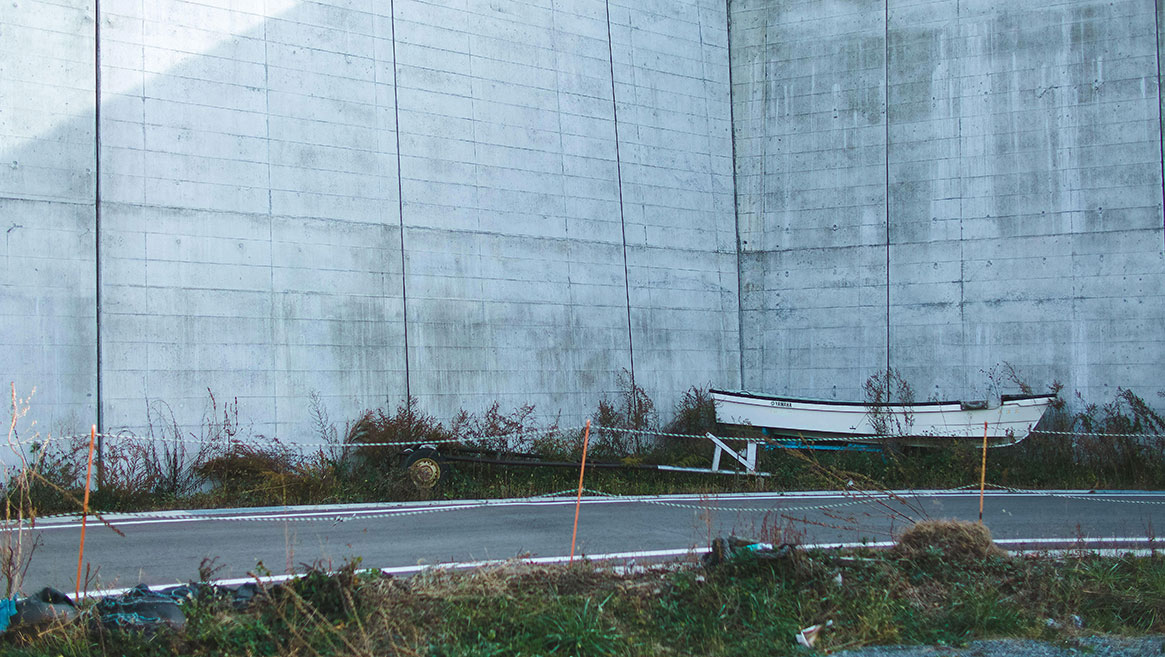 In many of Japan’s coastal communities, miles of protective concrete infrastructure have replaced water views and access. Photo by Nicolas Datiche/AFLO/Alamy