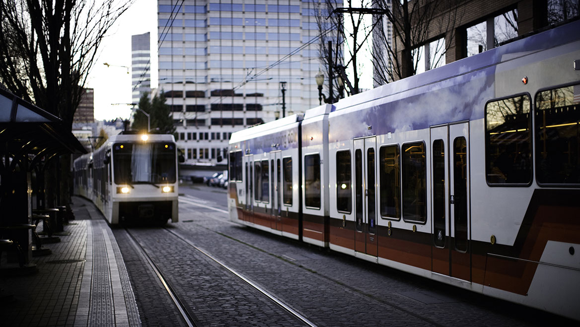 Rail train cars in downtown Portland, Oregon. The city plans on expanding the system’s Southwest Corridor. Photo by Ryan J Lane/E+/Getty Images.