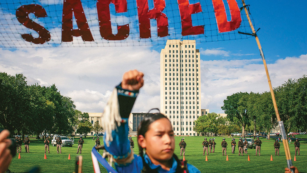 Native Americans protest the Dakota Access Pipeline near the North Dakota state capitol in Bismarck. Photo by Alyssa Schukar/The New York Times.