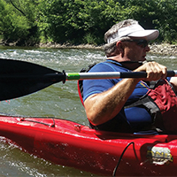 Tollakson in kayak Tollakson participates in a paddle outing with local elected officials to help build awareness of the Water Trails project.