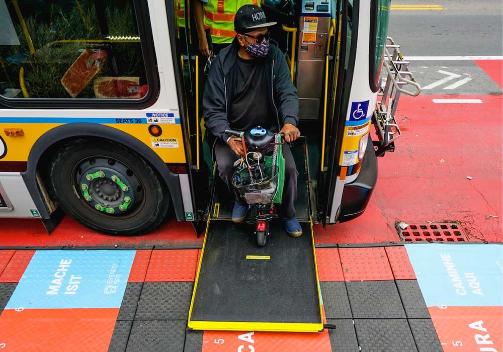 A raised bus boarding platform featuring on-ground signage with social distancing guidance in Everett. Photo by BostonBRT.