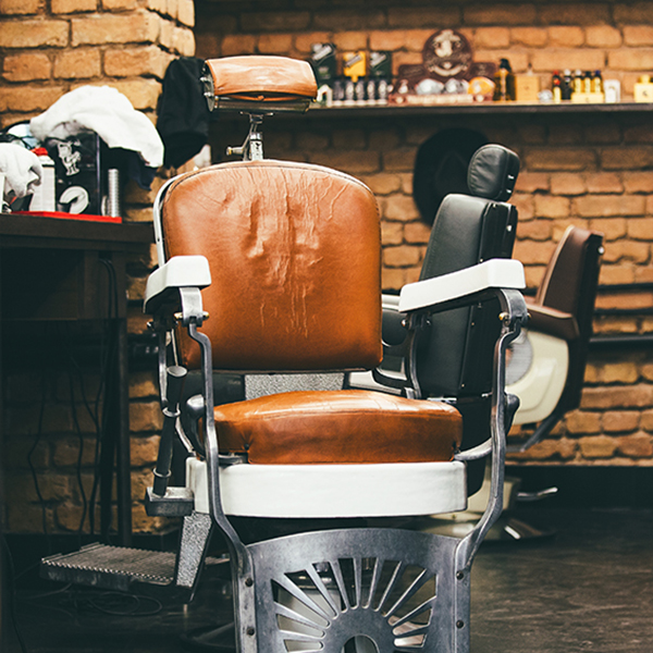 With Minimums: Inefficiencies. Locales dictate two spaces per chair at a barber shop when a barber’s chair can only hold one person at a time. Photo by stefanamer/iStock/Getty Images Plus.