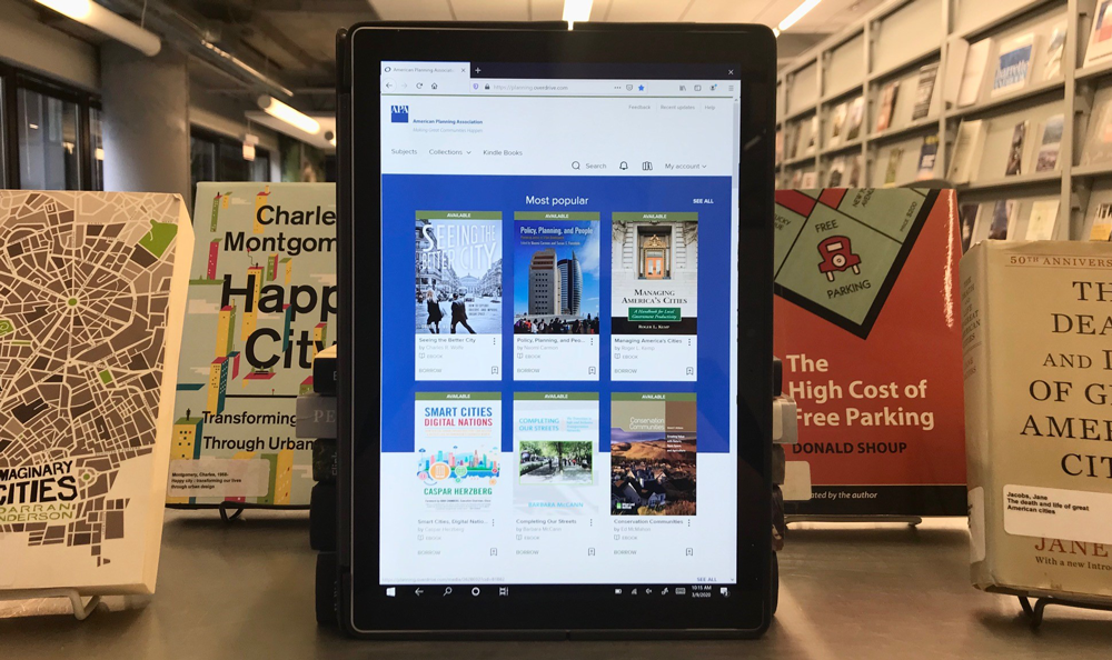 E-book Collection in the Library A tablet displays the homepage for the E-book Collection while sitting in the APA Library.