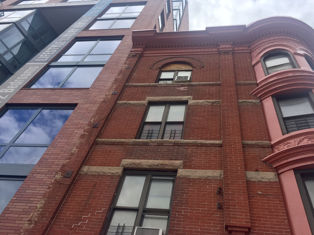 Luxury apartments (left) are swallowing existing affordable housing (right) along 4th Avenue. Photo by Lindsay Nieman.